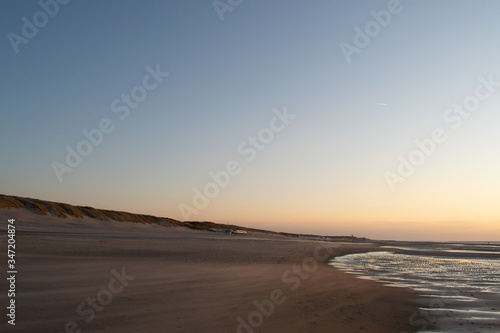 Sand dunes near to the sea sundowner © Marie
