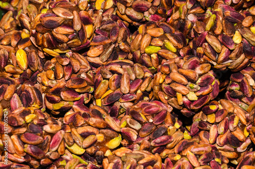 Turkish fruit and nut candy. Scattered pistachio and almond nuts.