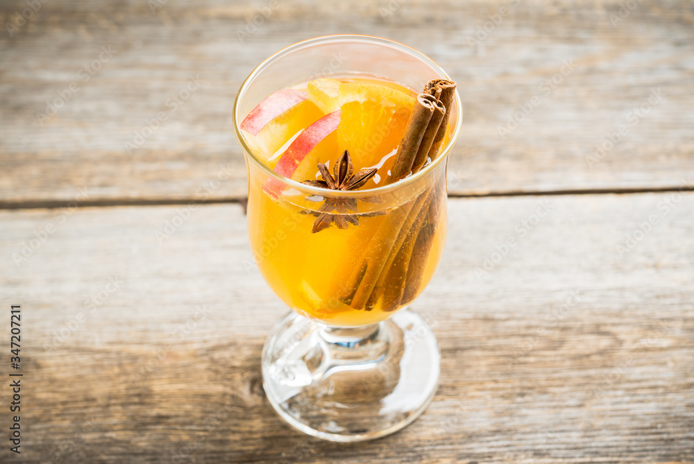 Healthy hot beverage with oranges, apples and spices for protection in flu season. Selective focus. Shallow depth of field. Healthy hot beverage with oranges, apples and spices for protection in flu season. Selective focus. Shallow depth of field.