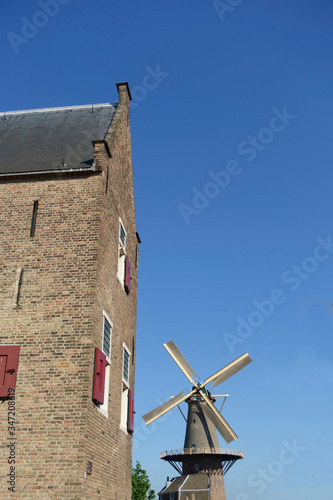 The Molen de Roos windmill in Delft with clear blue sky photo