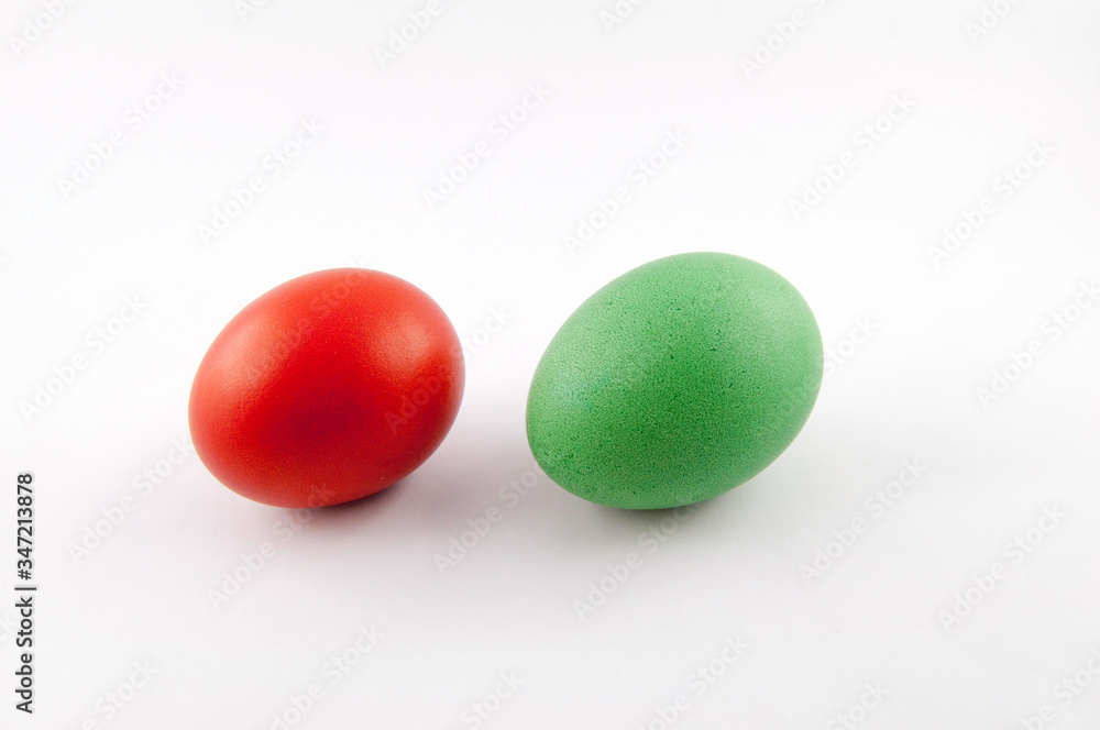 Two easter eggs, red and green, isolated on white background, colored by easter bunny Two easter eggs, red and green, isolated on white background, colored by easter bunny