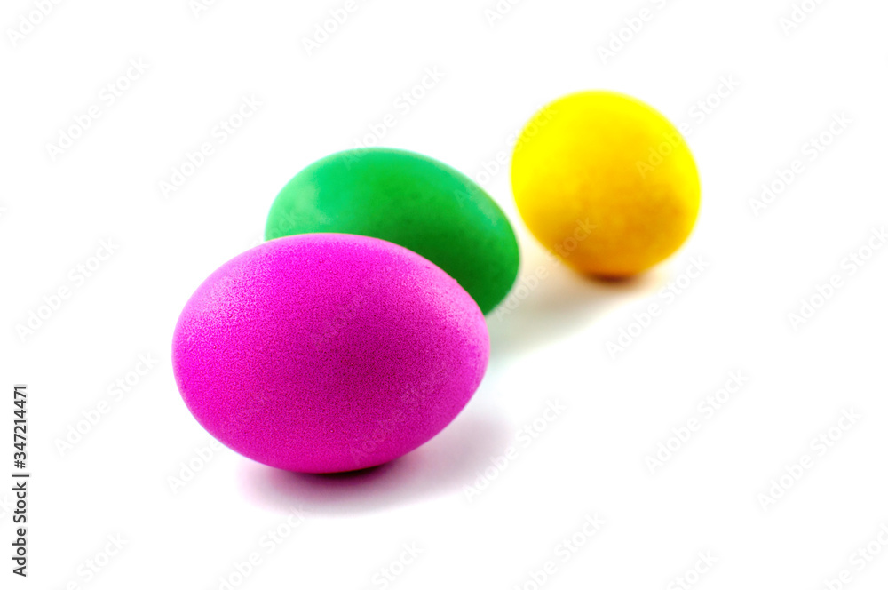Three easter eggs, red and green, orange or yellow, isolated on white background, colored by easter bunny Three easter eggs, red and green, orange or yellow, isolated on white background, colored by easter bunny