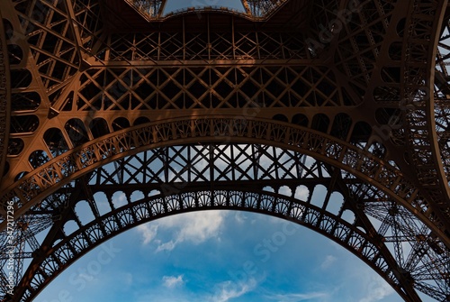 View from beneath Eiffel Tower with blue sky background © stockmagen