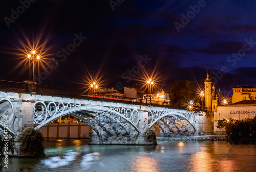 Seville, Spain, November 15, 2019: Seville Isabel II. Bridge in the nigh lighting © RobertMihaly