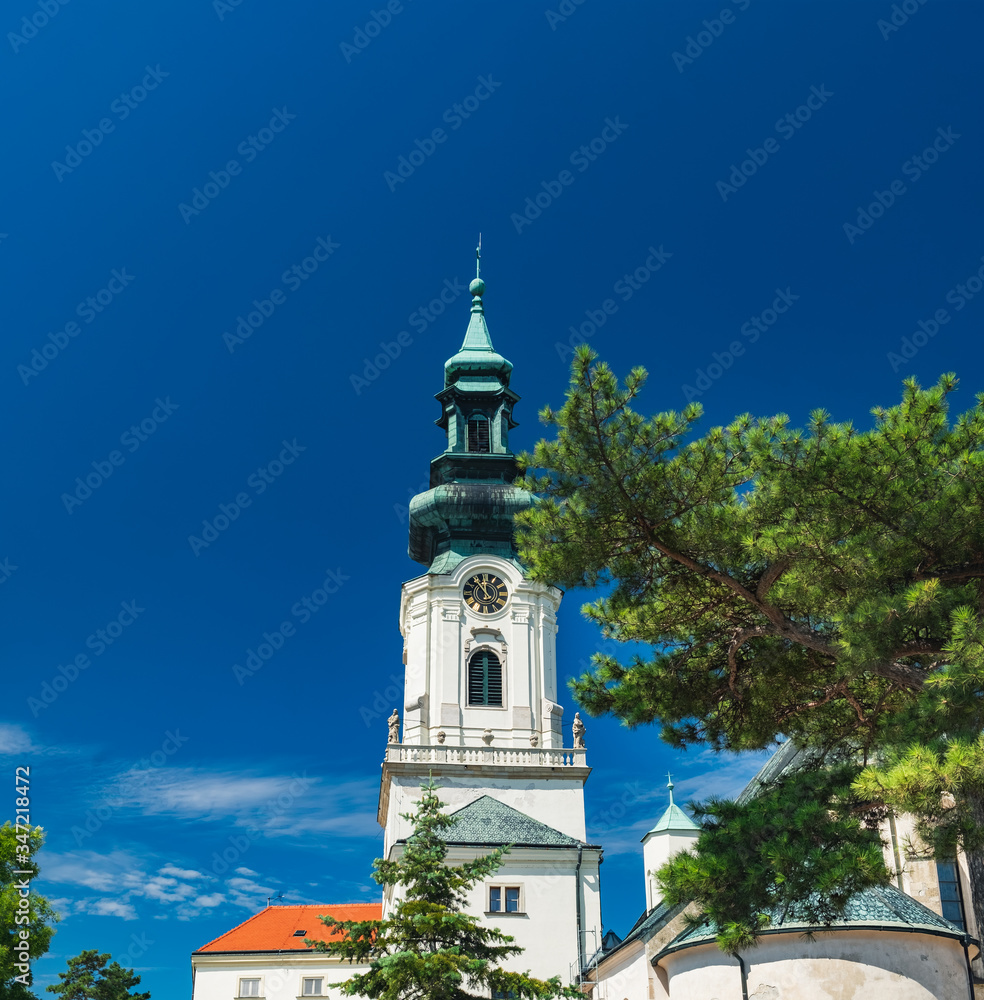 Obraz premium Nitra Castle located in Old Town of Nitra, Slovakia. Main entrance, Tower of Castle with clock under blue sky in beautiful summer day