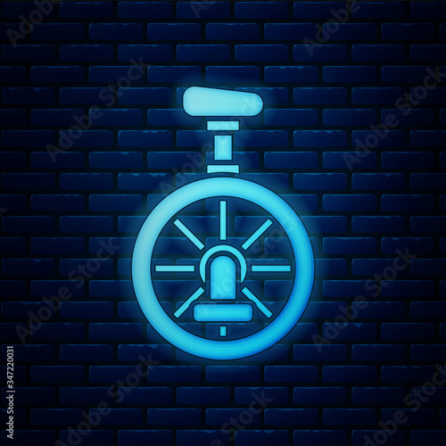Glowing neon Unicycle or one wheel bicycle icon isolated on brick wall background. Monowheel bicycle.  Vector Illustration