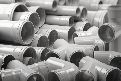 PVC plastic pipes and tubes stacked in warehouse. photo
