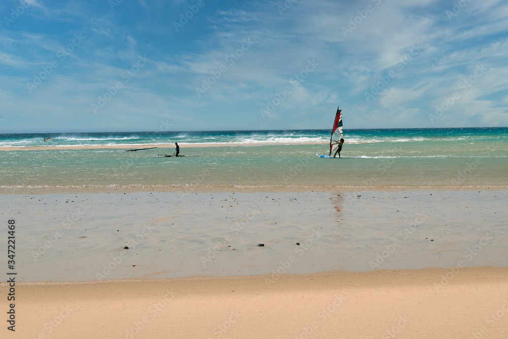 Group of surfers learning to surf on the beach shore in Fuerteventura