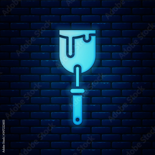 Glowing neon Putty knife icon isolated on brick wall background. Spatula repair tool. Spackling or paint instruments.  Vector Illustration