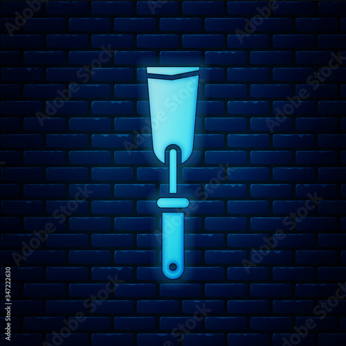 Glowing neon Putty knife icon isolated on brick wall background. Spatula repair tool. Spackling or paint instruments.  Vector Illustration
