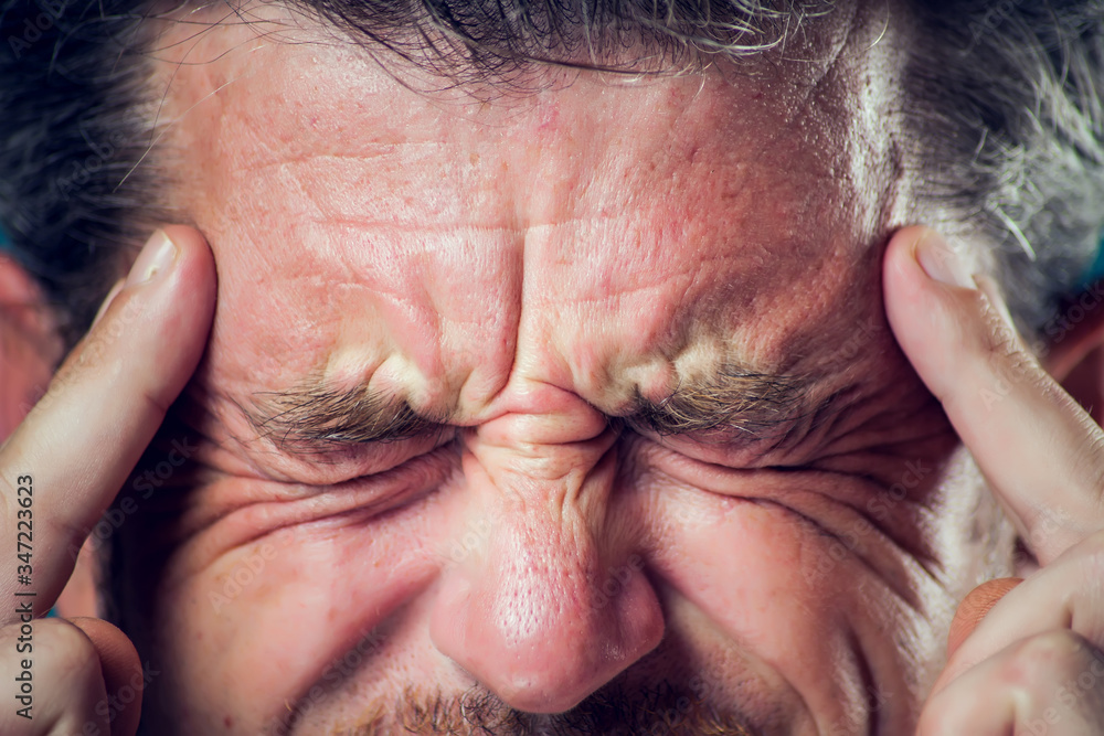 Fototapeta premium A man feeling headache. Close up. People, healthcare and medicine concept.