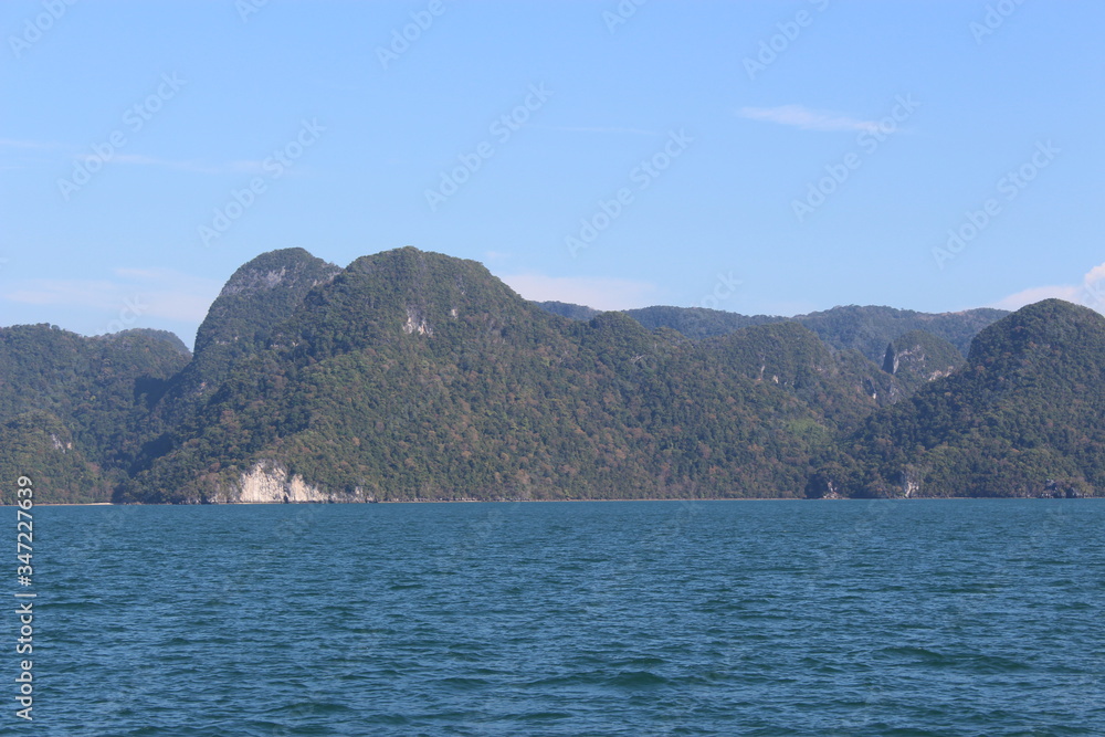 Lush green hilly islands inside the sea in Langkawi, Malaysia