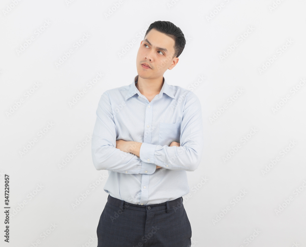 Young handsome asian man thinking an idea while looking up with arms crossed isolated on white background. Young handsome asian man thinking an idea while looking up with arms crossed isolated on white background.