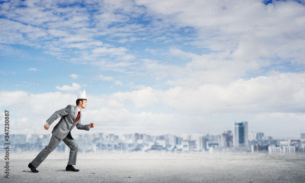 King businessman in elegant suit running and business center at background King businessman in elegant suit running and business center at background