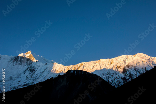 amazing sunset over the glaciers of the snow capped annapurnas mountains in the nepali himalayas. Tilicho Range, Annapurna round circuit photo