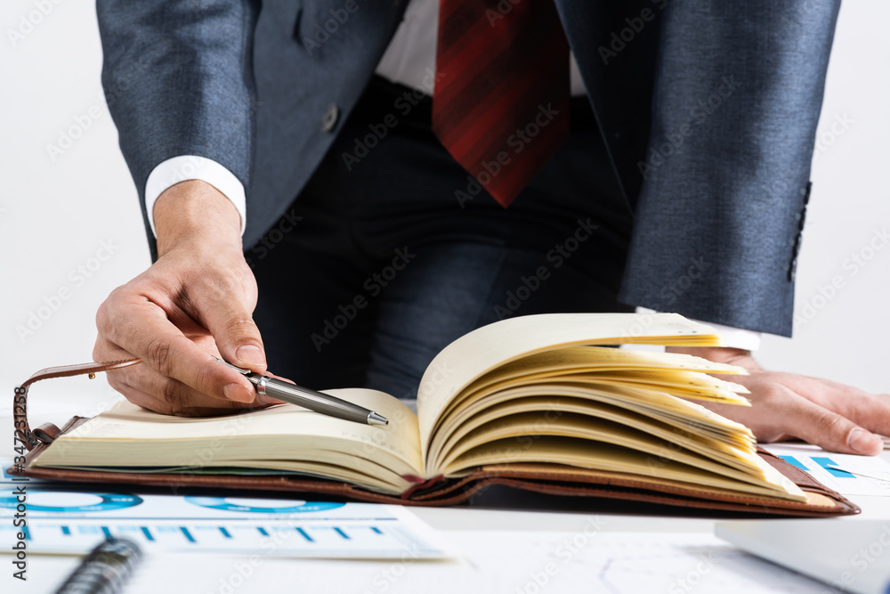 Businessman analyzing financial documents at desk Businessman analyzing financial documents at desk