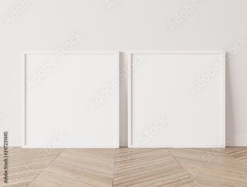 Two square white frames mock up. Two mock up posters standing on wooden floor  3D illustration 