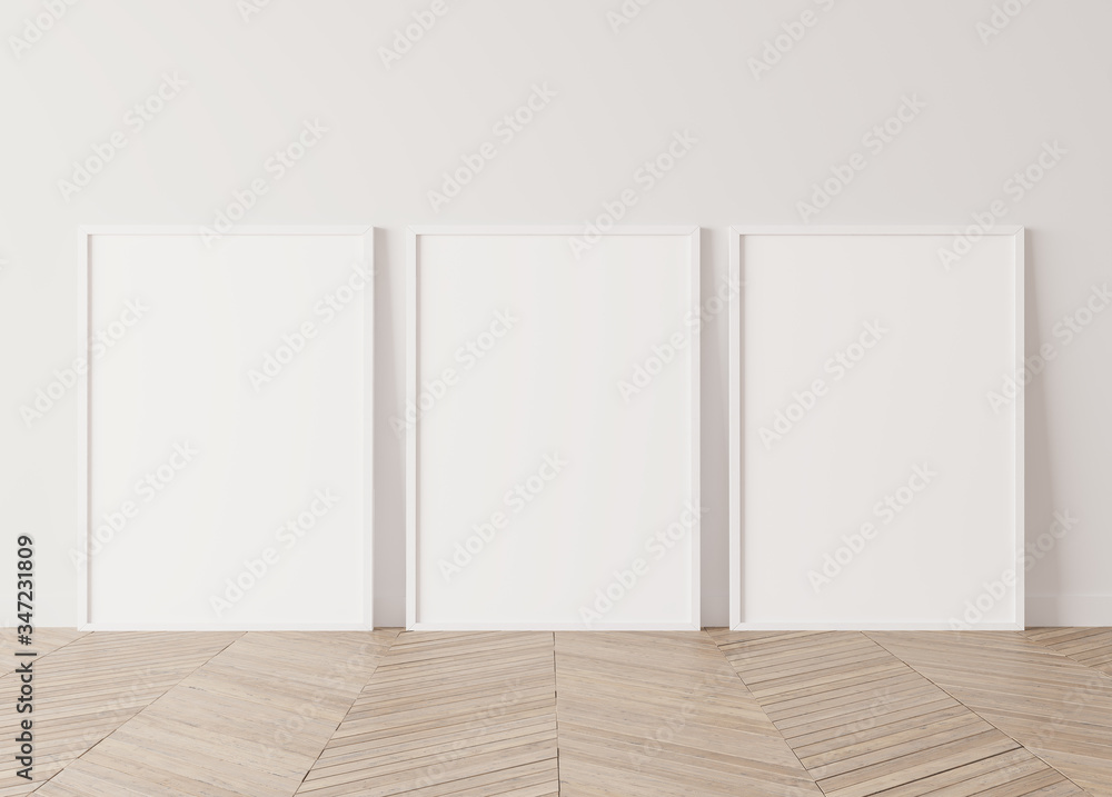 Three white vertical frames Standing on parquet floor with white background, minimal frame mock up interior Three white vertical frames Standing on parquet floor with white background, minimal frame mock up interior