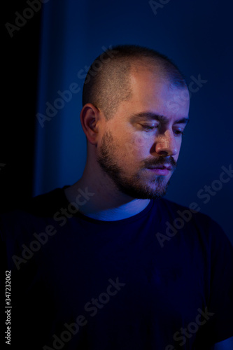 Man with shaved hair sad