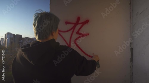 Urban Teen Drawing Graffitti On Wall