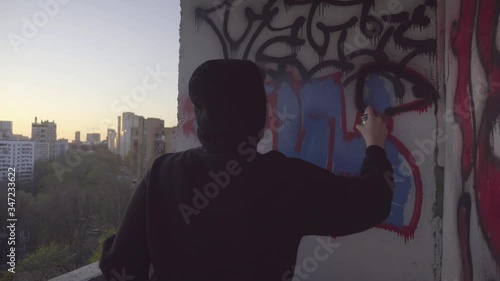Urban Teen Drawing Graffitti On Wall