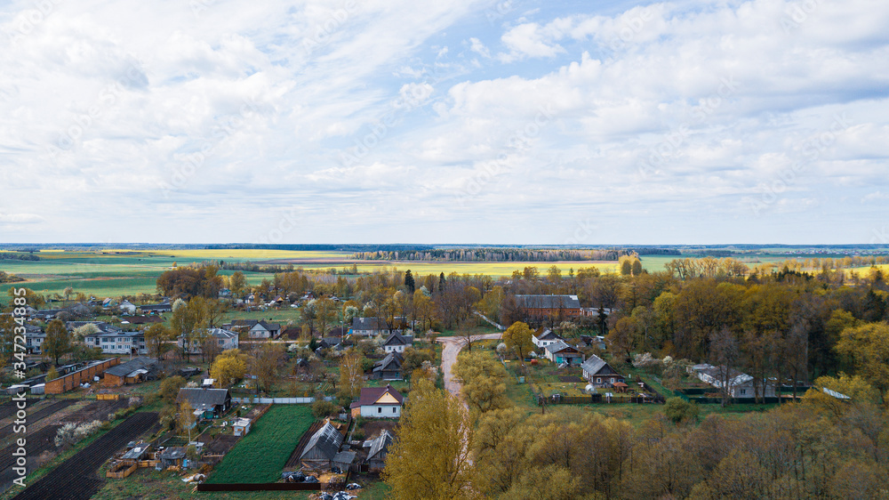 Aerial view over the rural landscape. Small village and nature background.