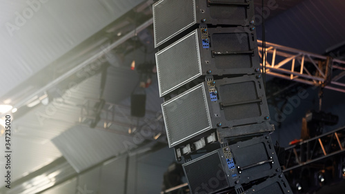 Professional audio equipment suspended from the ceiling. Audio speakers for events