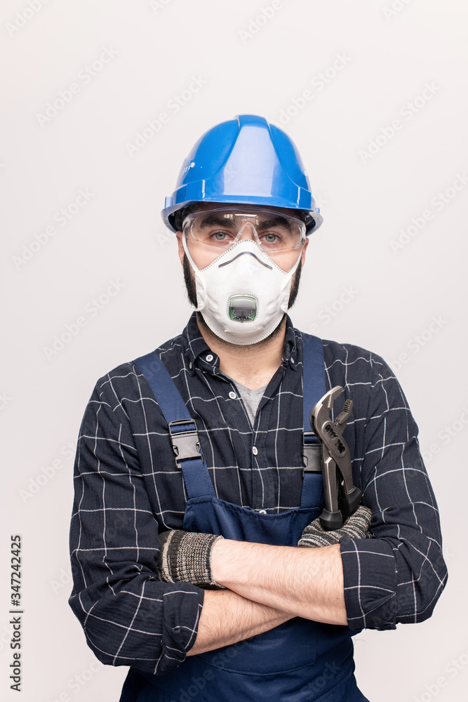 Cross-armed engineer or repairman in protective workwear looking at you Cross-armed engineer or repairman in protective workwear looking at you