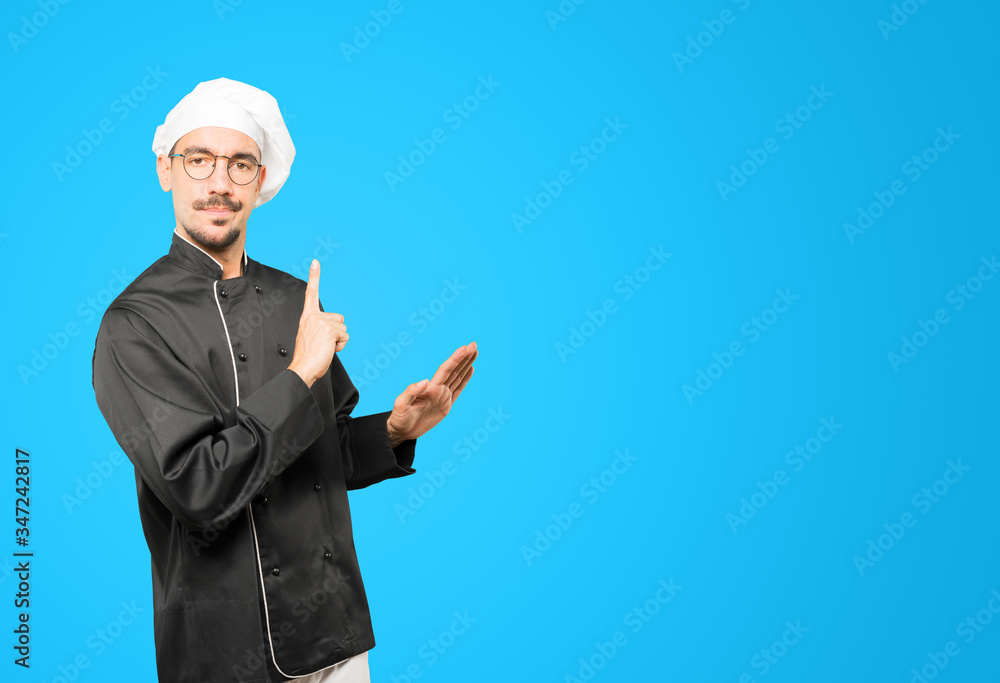 Haughty young chef making a contemptuous gesture Haughty young chef making a contemptuous gesture