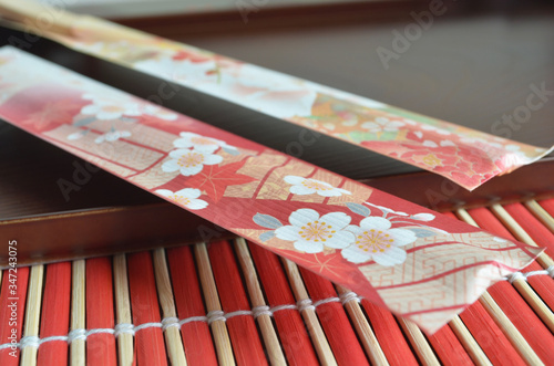 Japanese background design, bamboo chopsticks on the wooden tray. photo