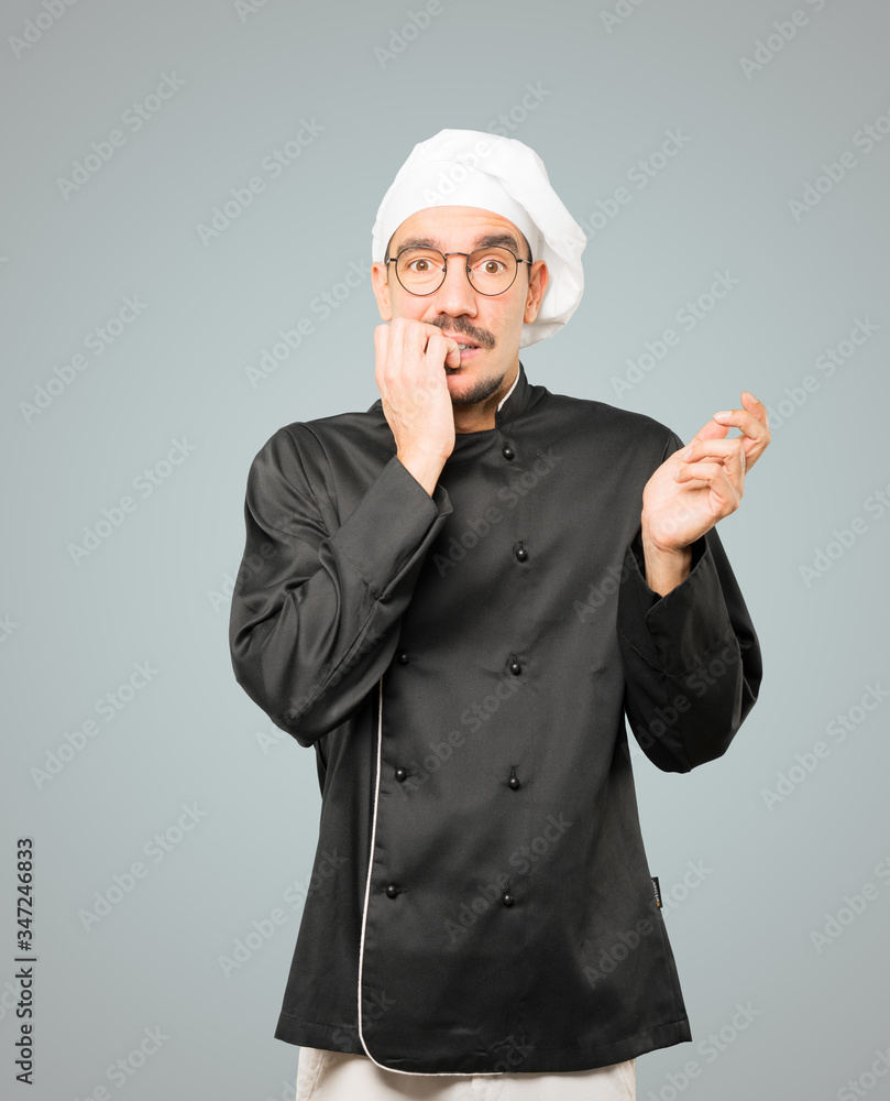 Crazy young chef making a nervous gesture Crazy young chef making a nervous gesture