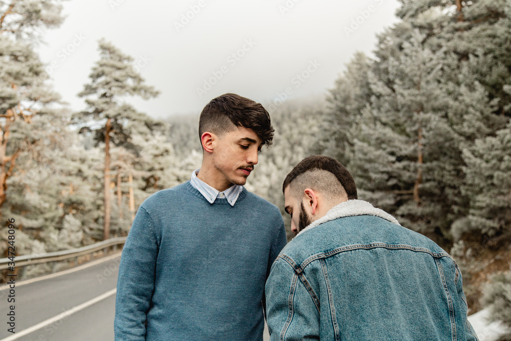 Gay couple in love on a mountain road Gay couple in love on a mountain road