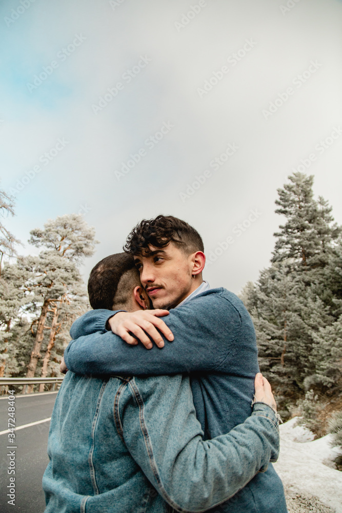 Gay couple in love on a mountain road Gay couple in love on a mountain road