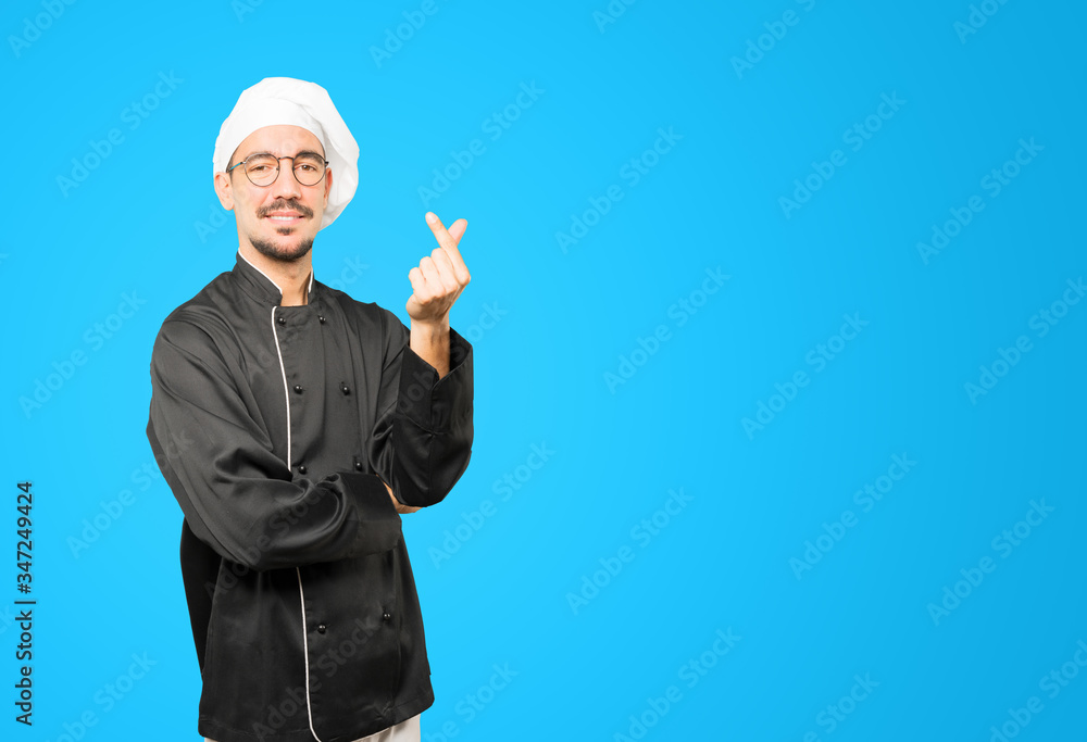 Young chef making a gesture of worried about his economy Young chef making a gesture of worried about his economy
