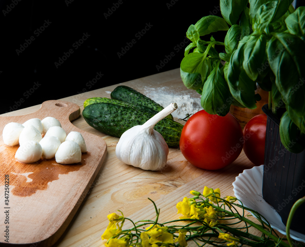 
Green cucumber and Vegetables for making pizza. Ready free space for text.