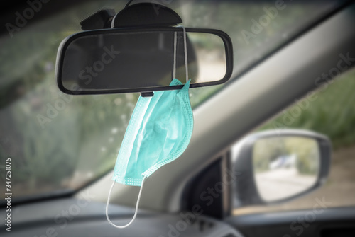 The medical mask weighs in the car. Polluted air infected from infection, pandemic, mask in the car for safety and prevention of coronovirus infection. The concept of infection prevention.