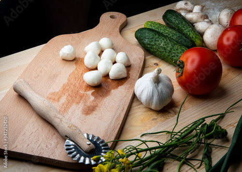 
Green cucumber and Vegetables for making pizza. Ready free space for text.