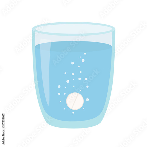 A glass of water with pill. Anesthetic medication.