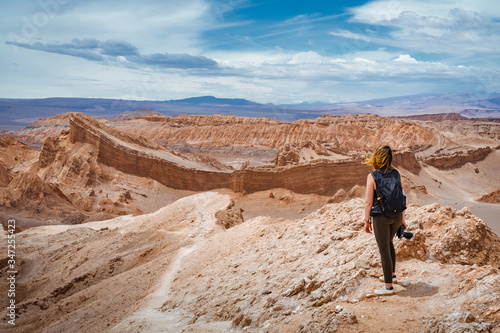 Female traveller exploring the Moon Valley (Spanish: Valle de la Luna) in the Atacama Desert, northern Chile, South America.