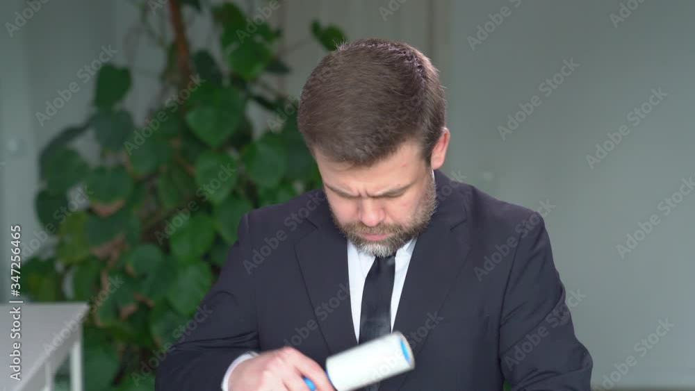 business man clean a sticky roller clothes business man clean a sticky roller clothes