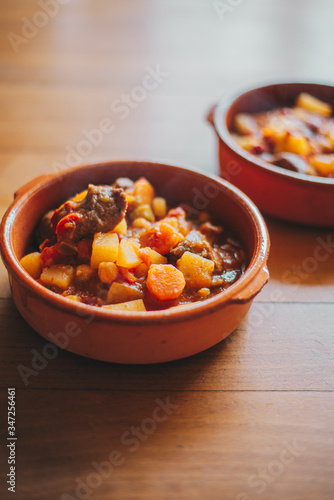 potatoes and meat stew on a clay container