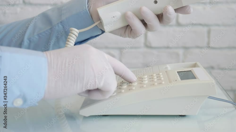 Slow Motion with a Man Wearing Protection Gloves in Hands Cleaning and Disinfecting a Telephone Using a Spray and Wet Wipes Slow Motion with a Man Wearing Protection Gloves in Hands Cleaning and Disinfecting a Telephone Using a Spray and Wet Wipes