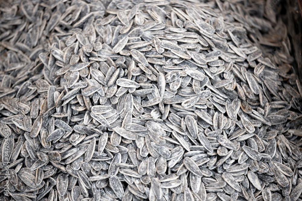 Sunflower seeds in black and white. Photographed on the counter in front of the salted and roasted market. Close up. Sunflower seeds in black and white. Photographed on the counter in front of the salted and roasted market. Close up.
