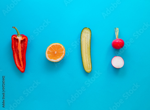 Flat lay top view of fresh vegetables over pastel blue backdrop with minimal style, copy space © Solidasrock