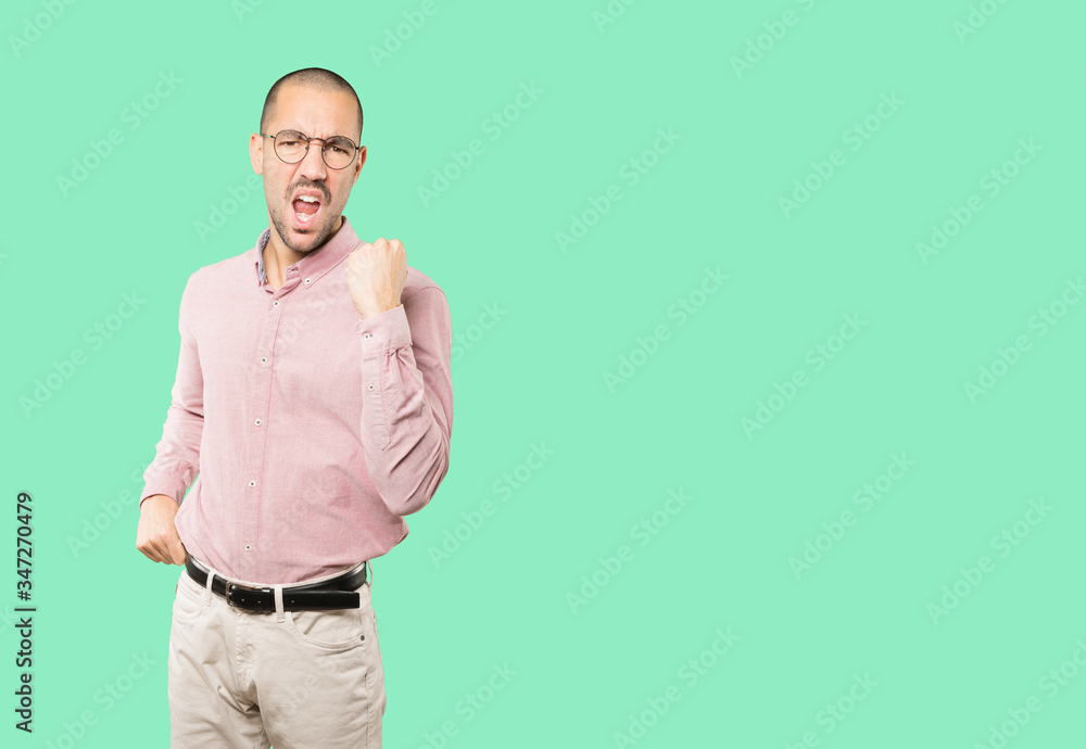 Upset young man doing a competitive gesture Upset young man doing a competitive gesture