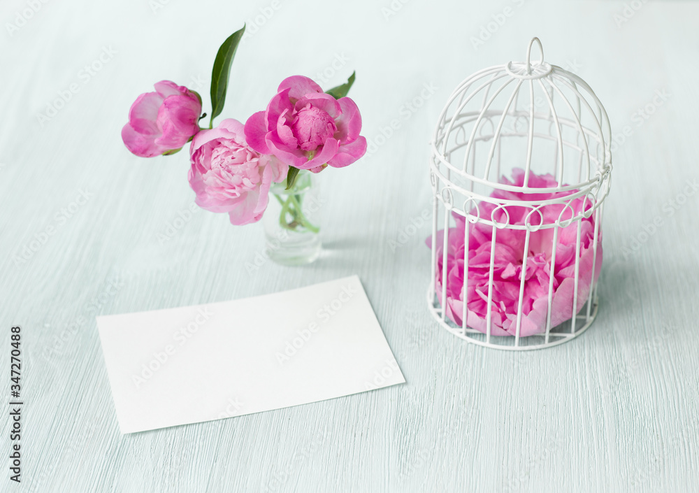 Small bird cage with peony flower bouquet, invitation card template with text space, Modern scandy style interior.