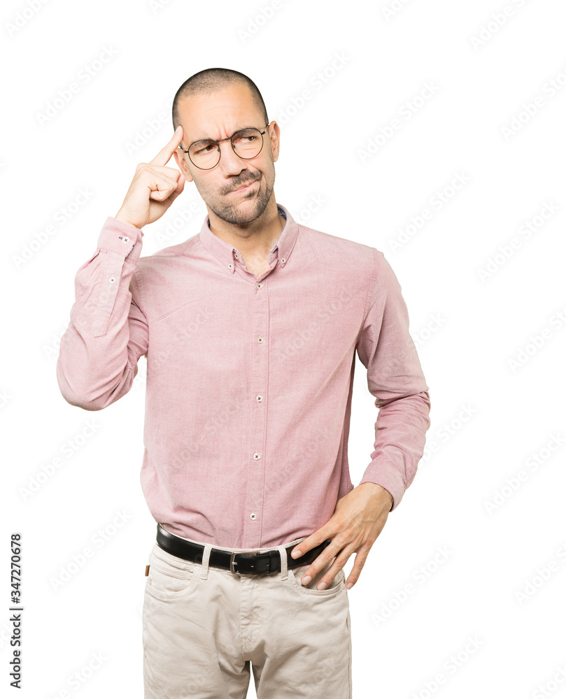 Serious young man doing a gesture of concentration Serious young man doing a gesture of concentration