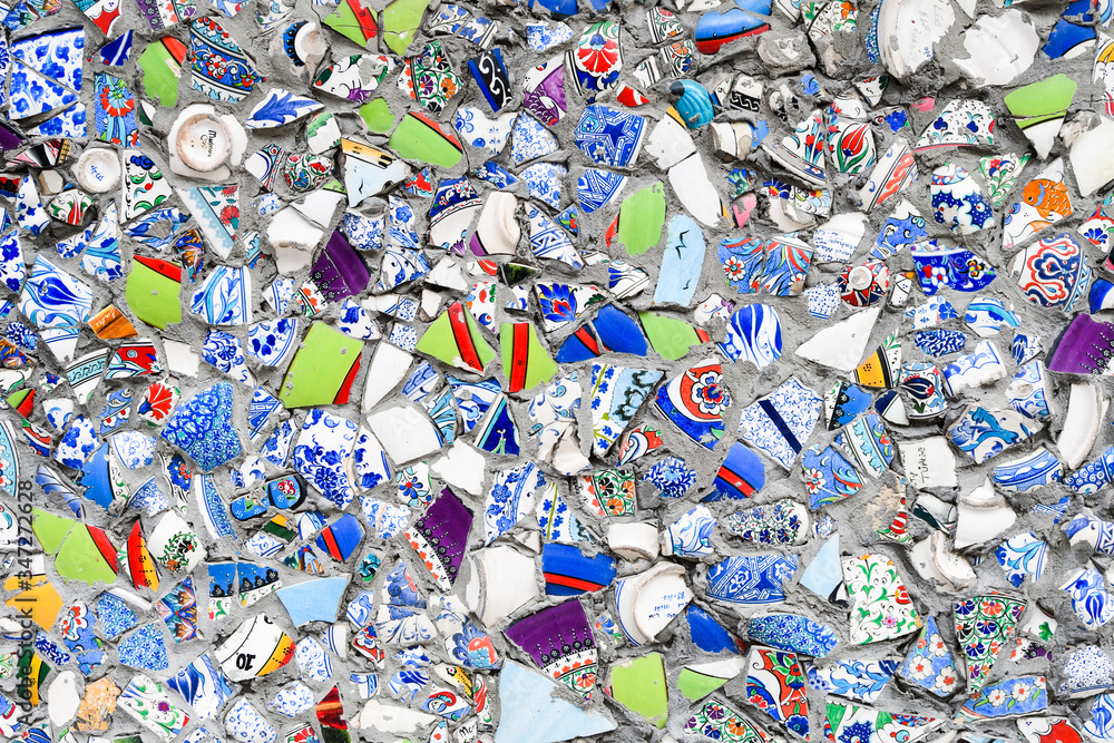 Close up of a wall, decorated with broken pieces of handmade ceramic pots. Close up of a wall, decorated with broken pieces of handmade ceramic pots.
