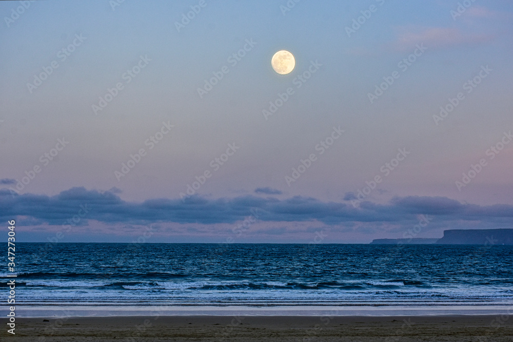 view of the moon over the beach view of the moon over the beach