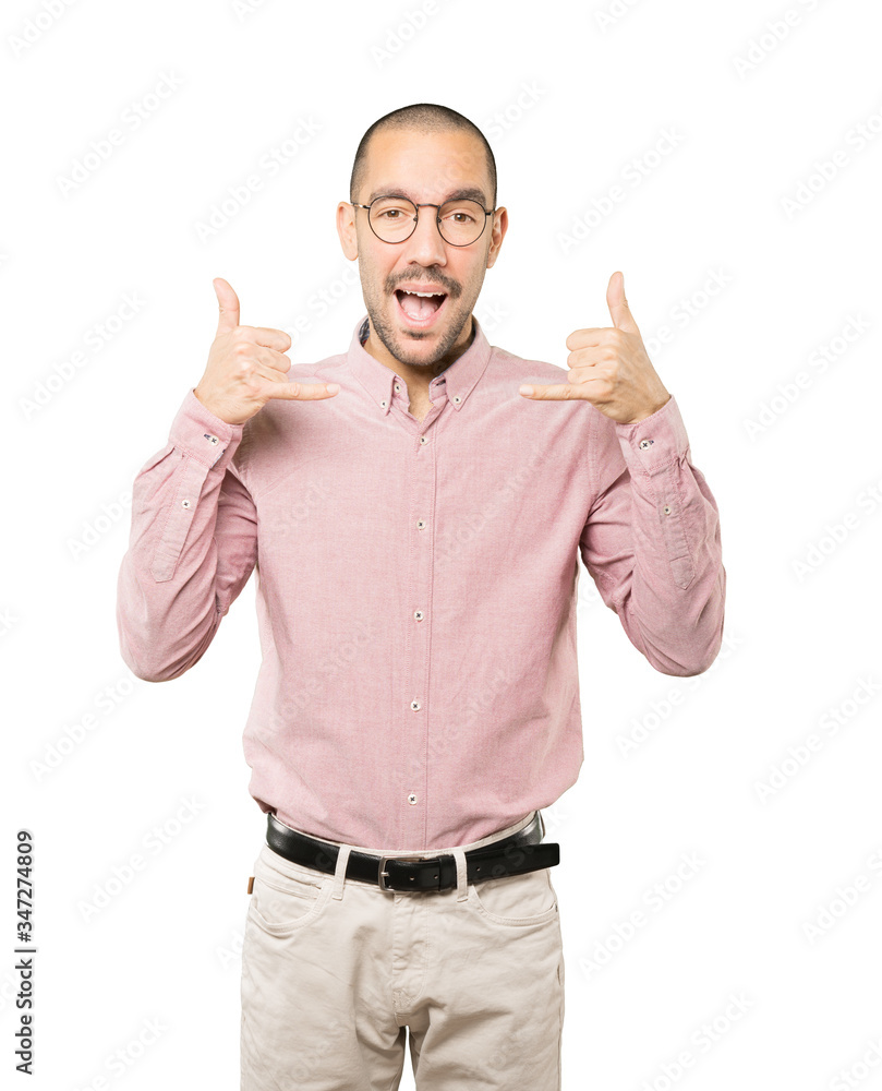 Amazed young man making a gesture of calling with the hand Amazed young man making a gesture of calling with the hand